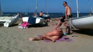Flawless topless blond butt on the beach