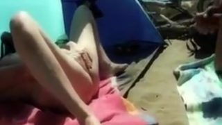 my wife masturbating and stroking my dick on the beach
