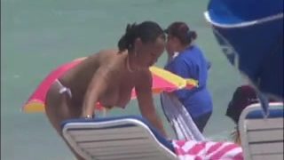 Plump breasted girl caught in a voyeur beach nudism video