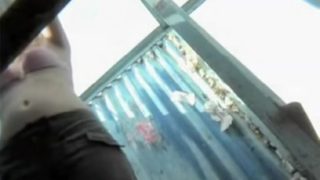 Blonde in beach change cabin taking off her cloths