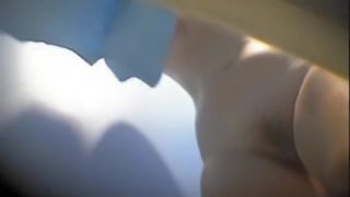 Changing room girl exposes her bushy cunt and small tits
