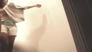 Leggy girls trying on summer dresses in fitting room