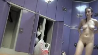 Slim bodied girl staying nude before changing room mirror